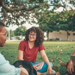 students sitting in a group outside